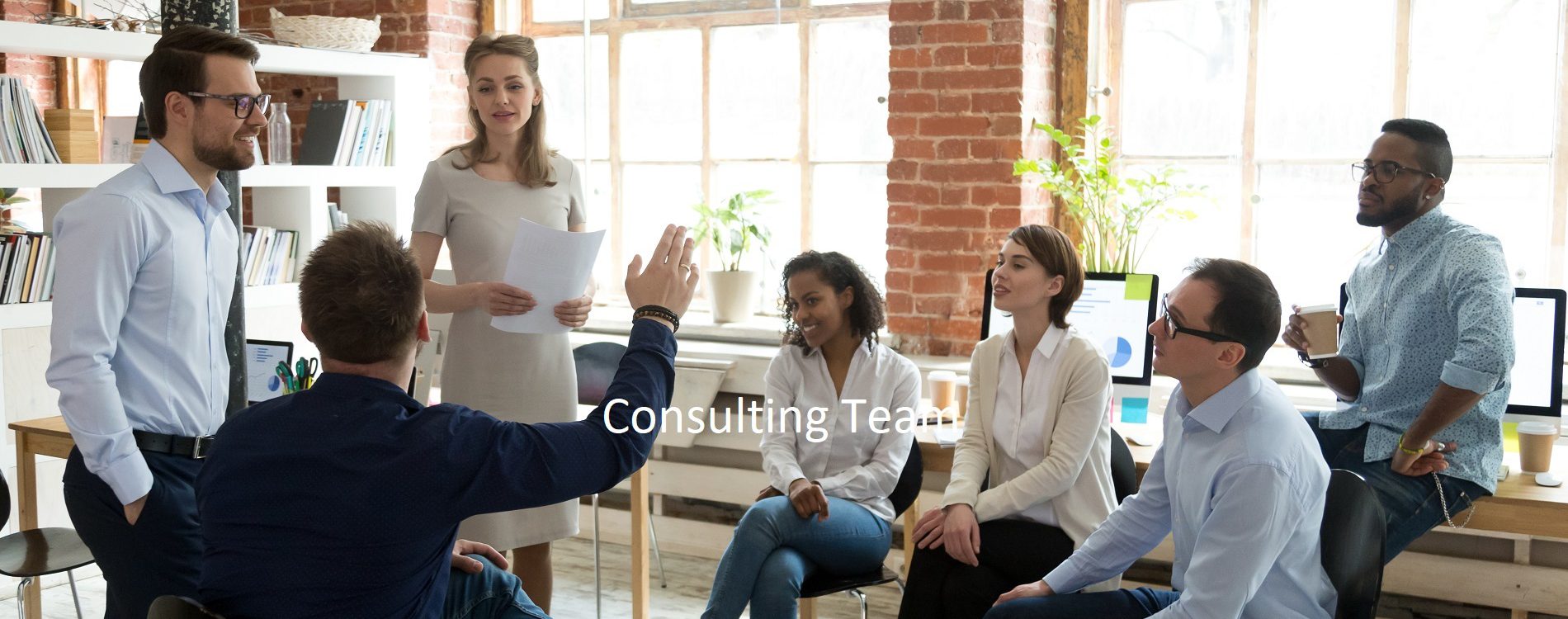 Ambitious male employee raise hand ask question to female presenter at meeting, man show activity at teambuilding with multiethnic colleagues, diverse workers brainstorm at office education briefing